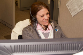 Smiling worker answering phone call